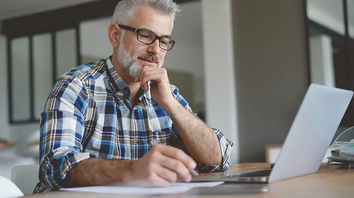  Man at desk with laptop