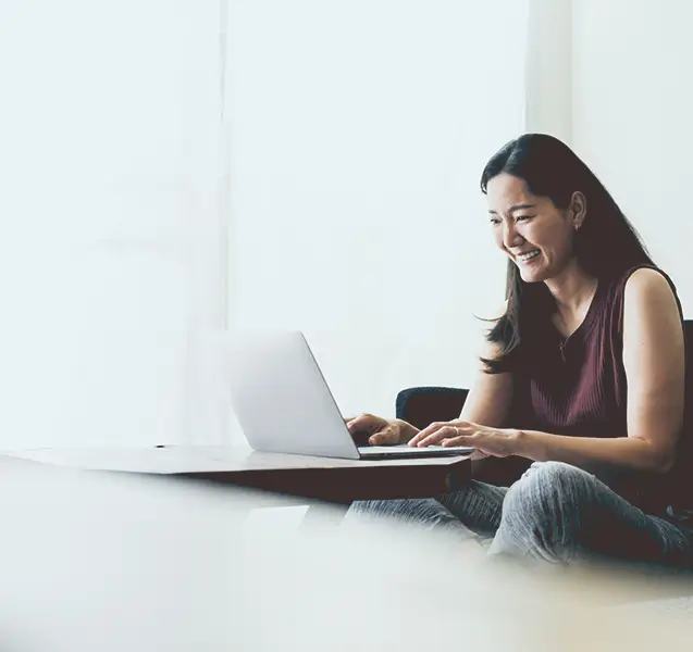 Woman sitting on couch with laptop